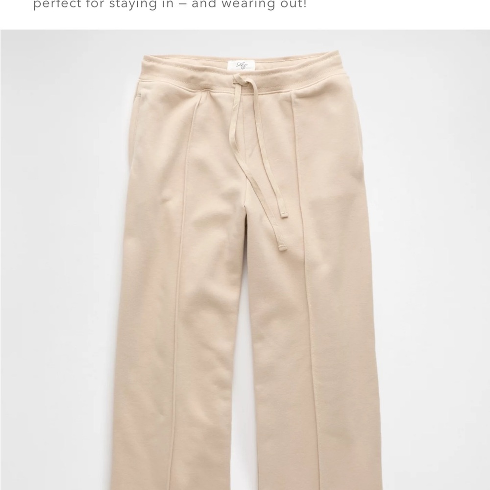 Cream colored sweat pants with Elastic Waistband and Relaxed Fit